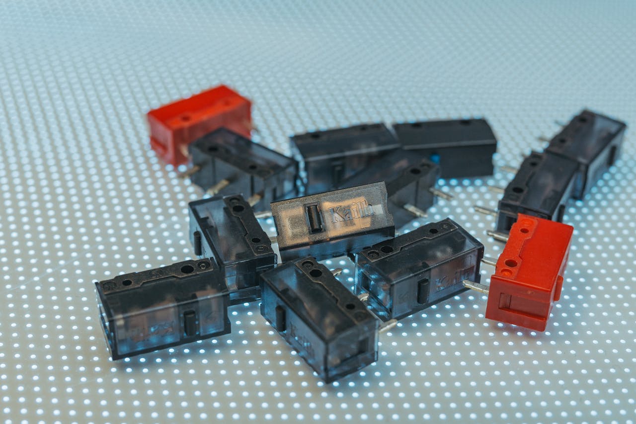 portfolio-05 Close-up of black and red electronic components arranged on a dotted LED surface.